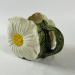 a large vintage daisy creamer with a large daisy forming the side of the pitcher. 