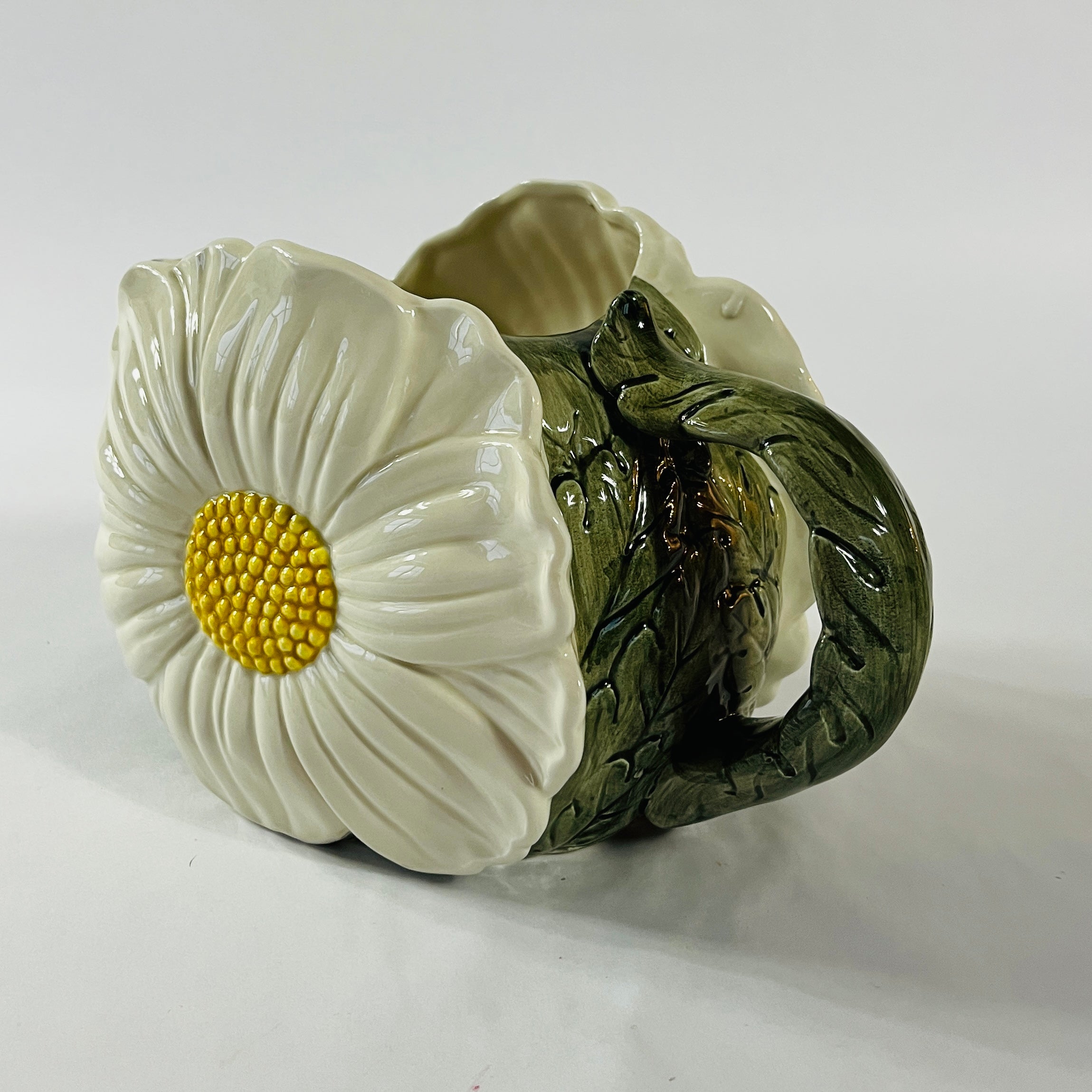 a large vintage daisy creamer with a large daisy forming the side of the pitcher. 