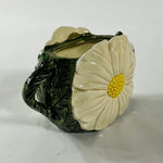 a large vintage daisy creamer with a large daisy forming the side of the pitcher. 