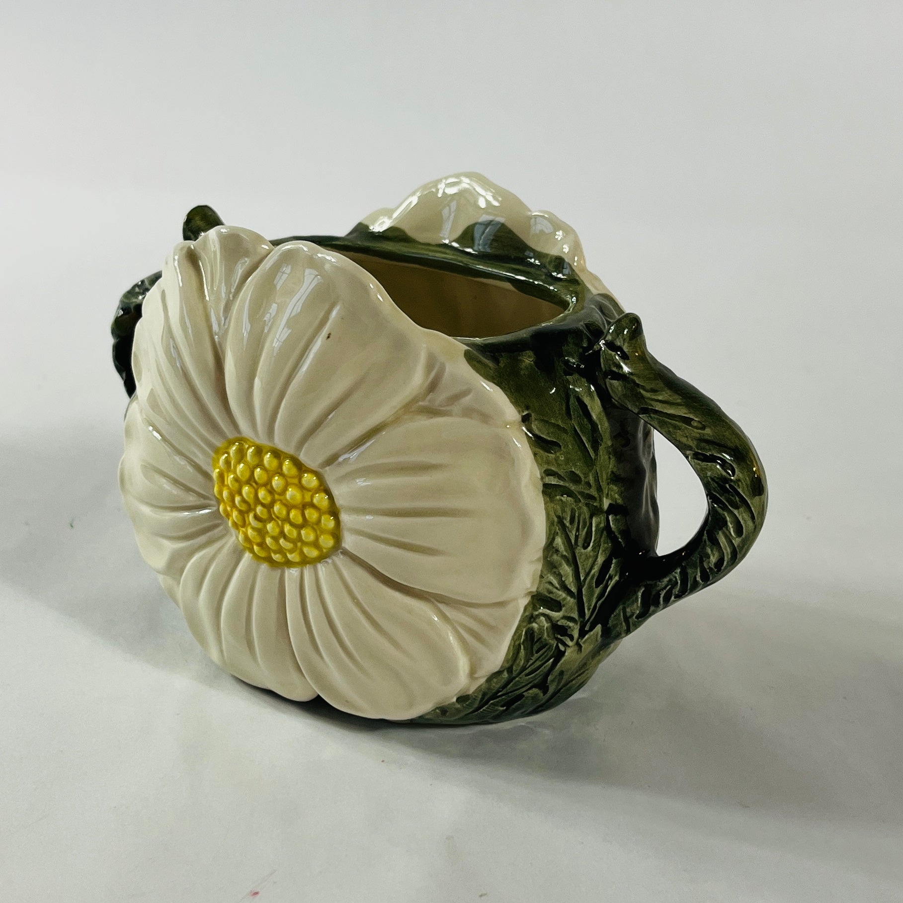 a large vintage daisy creamer with a large daisy forming the side of the pitcher. 