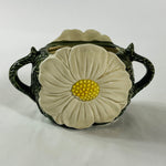 a large vintage daisy creamer with a large daisy forming the side of the pitcher. 