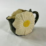 a large vintage daisy creamer with a large daisy forming the side of the pitcher. 