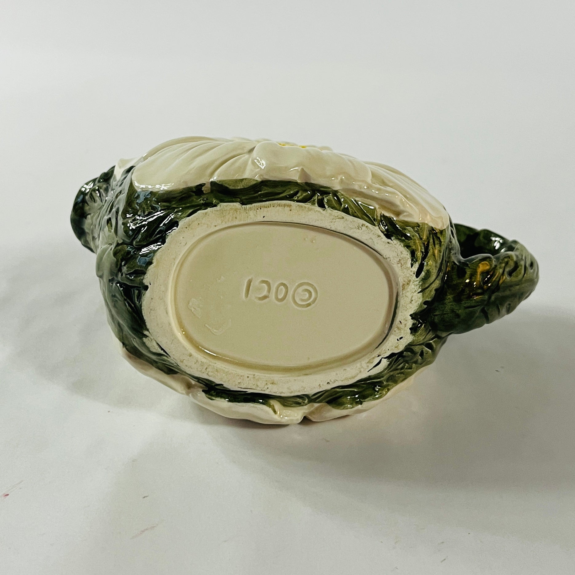 a large vintage daisy creamer with a large daisy forming the bottom of the pitcher. 