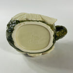 a large vintage daisy creamer with a large daisy forming the bottom of the pitcher. 