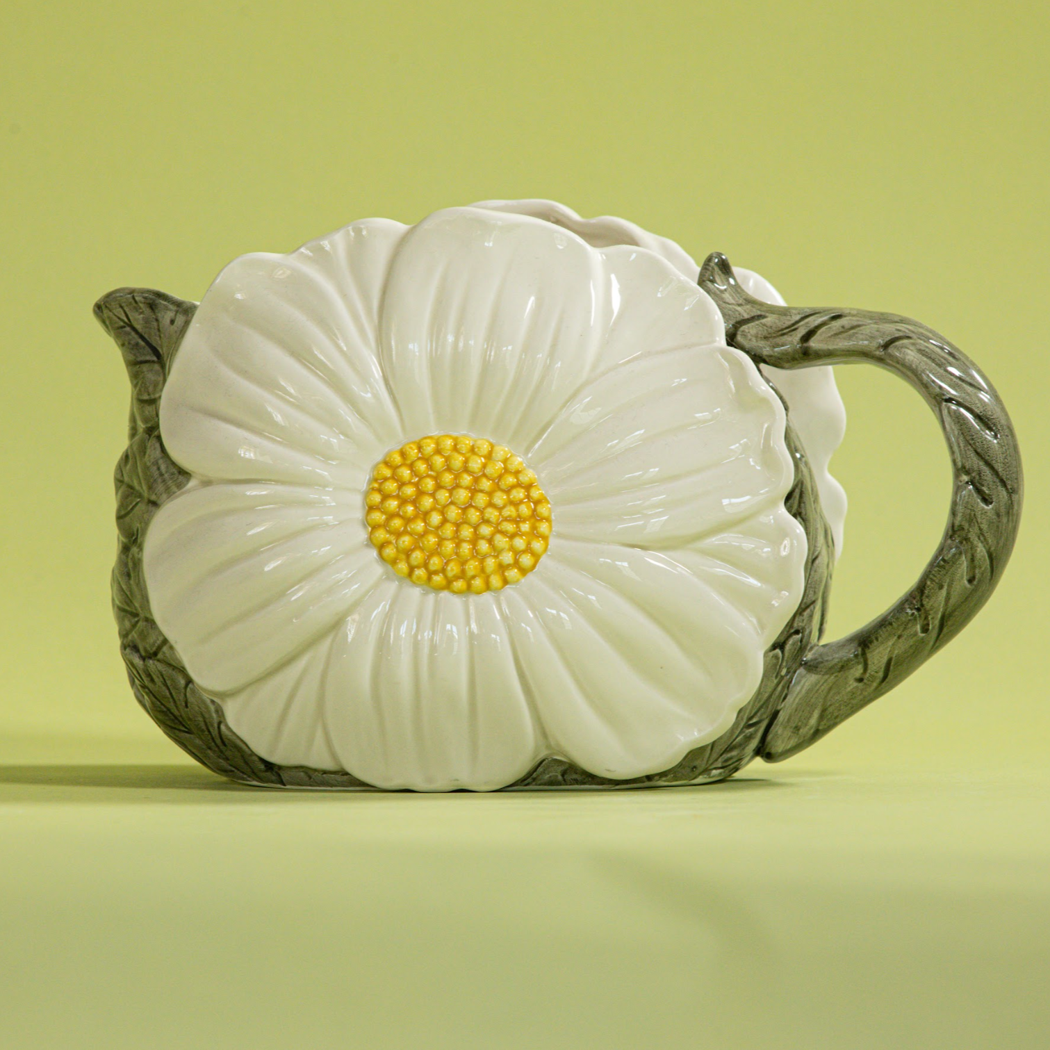 a large vintage daisy creamer with a large daisy forming the side of the pitcher. 