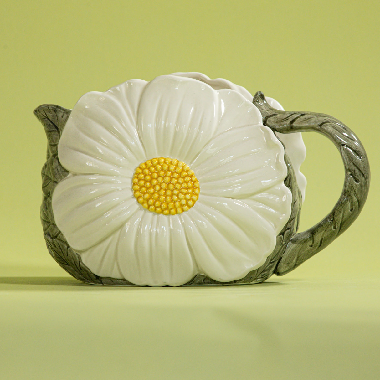 a large vintage daisy creamer with a large daisy forming the side of the pitcher. 