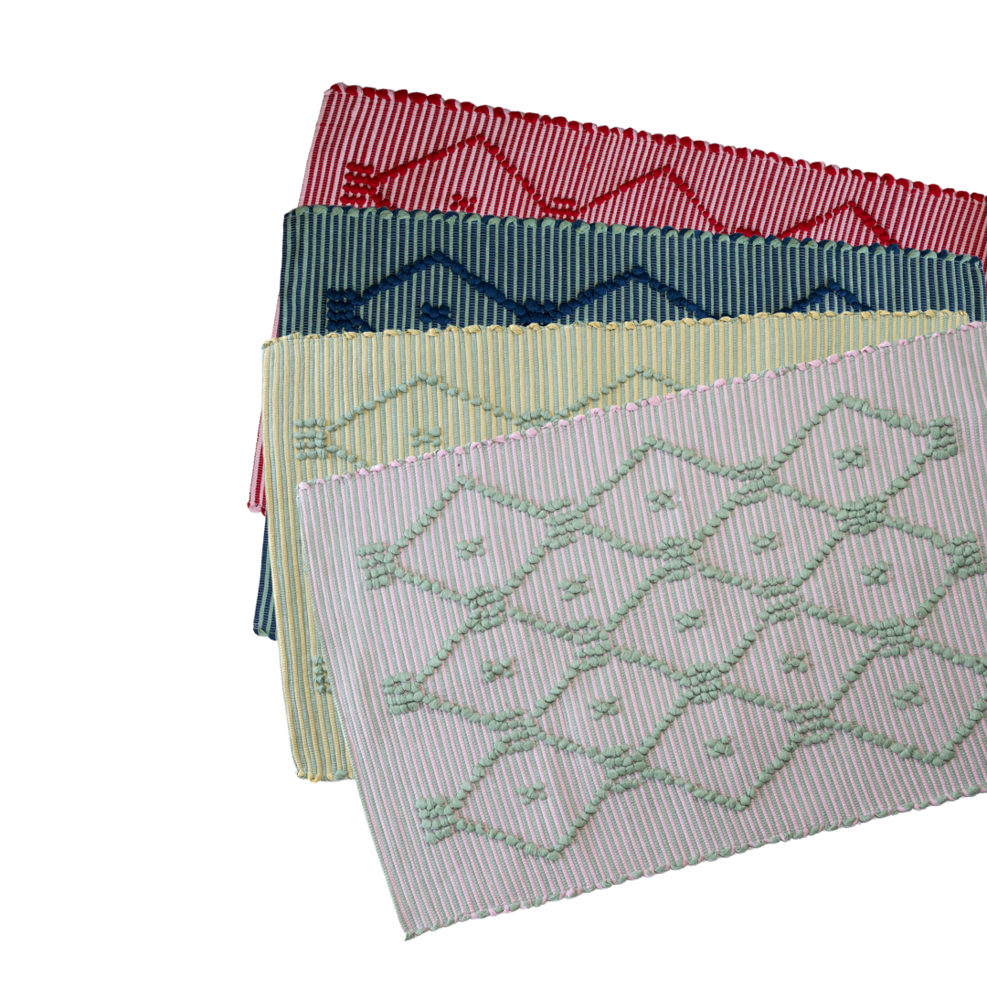 Four cotton accent rugs in red, navy, yellow and pink with a lattice motif from madcap cottage