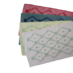 Four cotton accent rugs in red, navy, yellow and pink with a lattice motif from madcap cottage