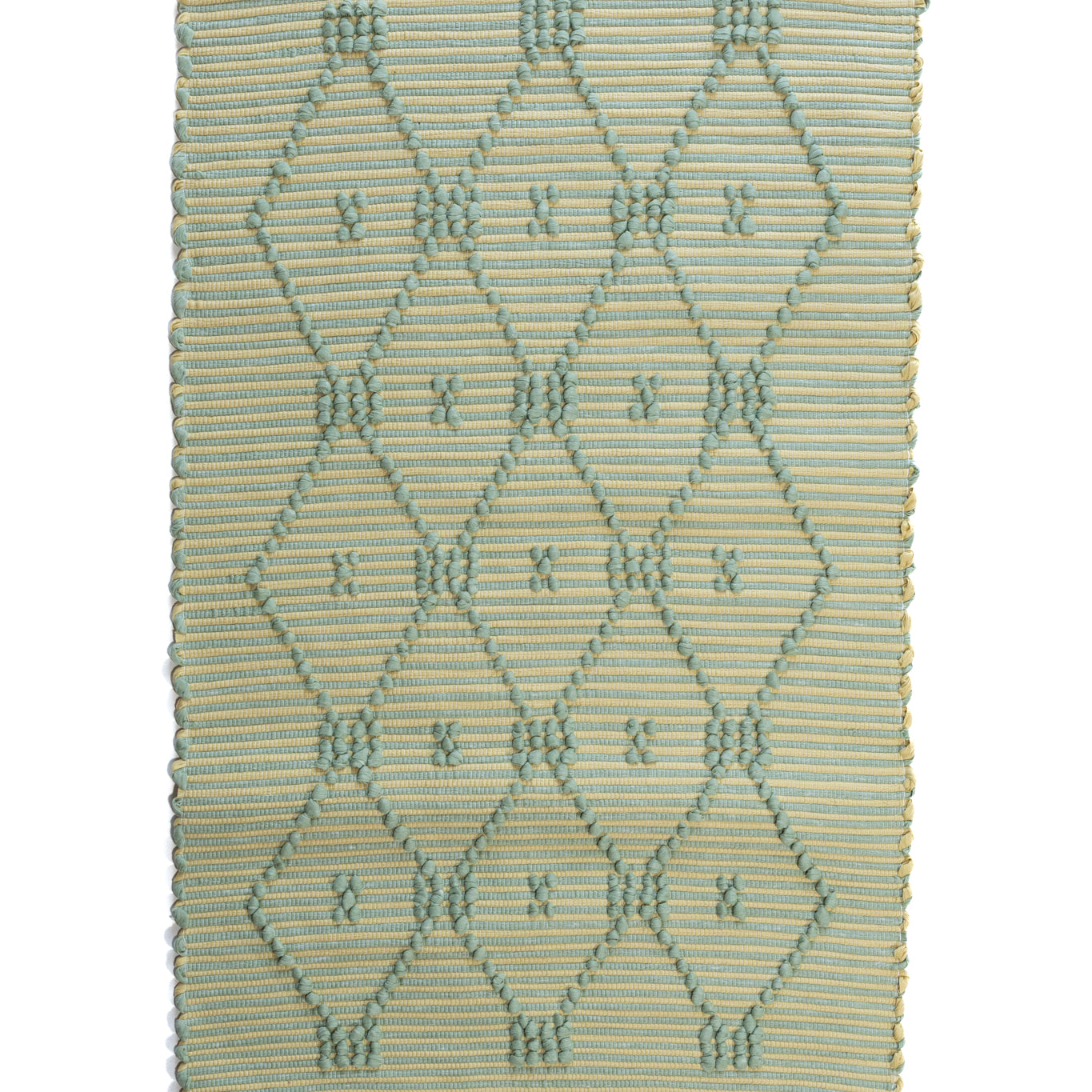 A madcap cottage yellow and green striped accent rug with a lattice motif across the front