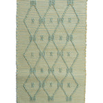 A madcap cottage yellow and green striped accent rug with a lattice motif across the front