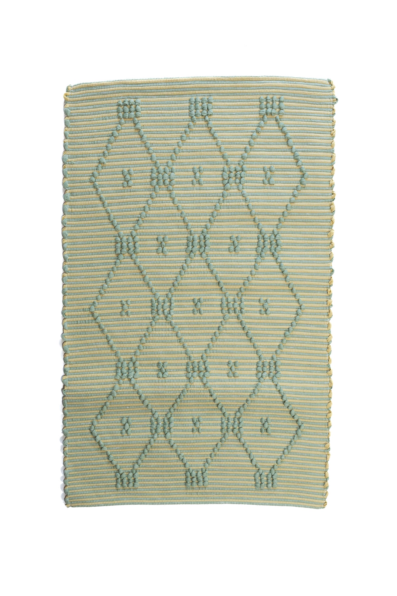 A madcap cottage yellow and green striped accent rug with a lattice motif across the front