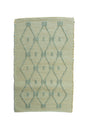 A madcap cottage yellow and green striped accent rug with a lattice motif across the front