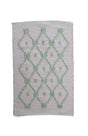 A madcap cottage pink and green striped accent rug with a lattice motif across the front