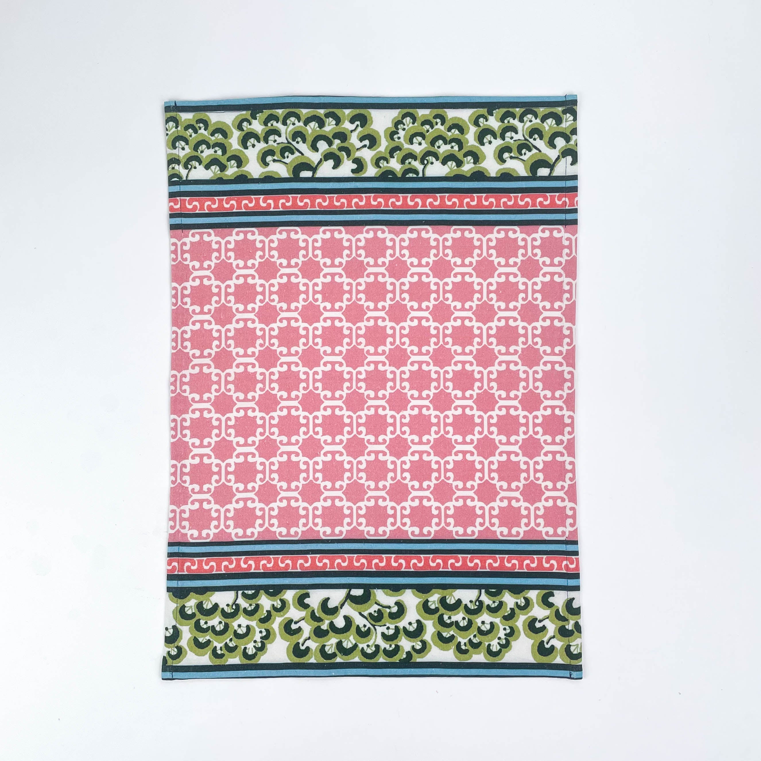 Christmas tea towel featuring a pink lattice pattern with green and white Chinoiserie-inspired borders