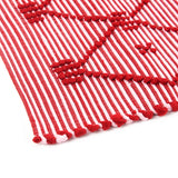close up look of A red accent rug with a lattice pattern on it