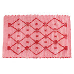 A red accent rug with a lattice pattern on it