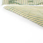 reverse side of A yellow/green accent rug with a lattice pattern on it