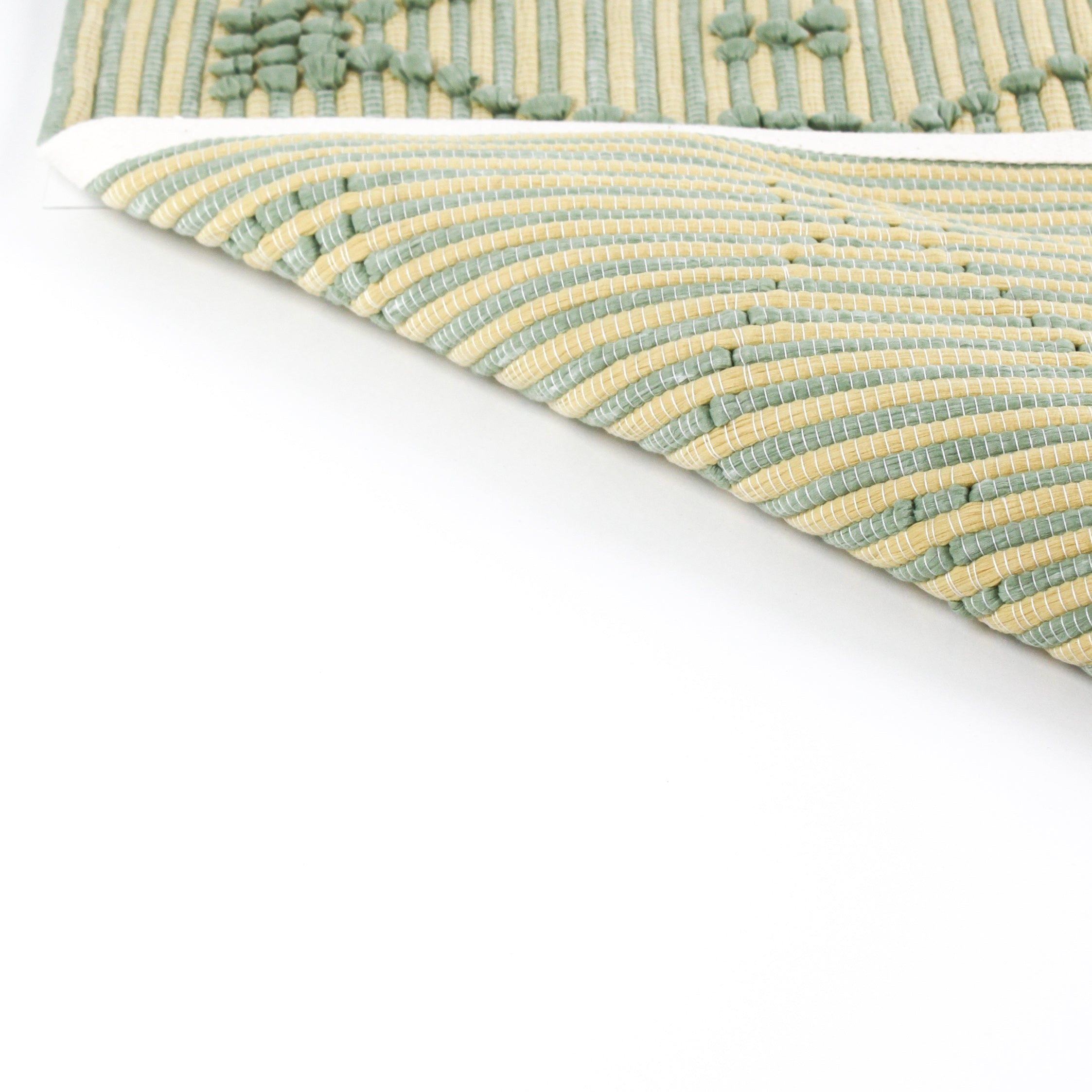 reverse side of A yellow/green accent rug with a lattice pattern on it
