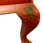 a dark wood chinoiserie side table with two tiers and on rolling casters.