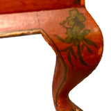 a dark wood chinoiserie side table with two tiers and on rolling casters.