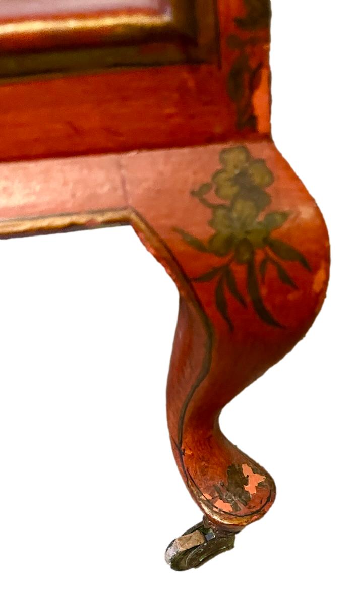 a dark wood chinoiserie side table with two tiers and on rolling casters.