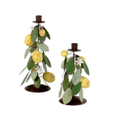 Two decorative lemon candle holders with lemons and leaves on a white background
