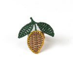  a lemon rattan napkin ring in the shape of a lemon with two green leaves against a white background