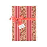 Stylish gift wrap featuring bold pink leopard prints, vibrant green accents, and elegant striped patterns.