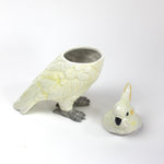 A white ceramic cockatoo from madcap cottage with the lid removed
