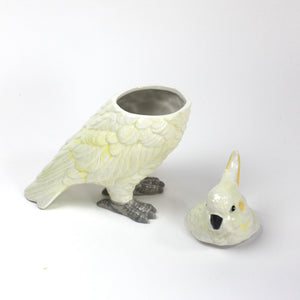 A white ceramic cockatoo from madcap cottage with the lid removed
