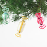 Colorful glass candy ornaments hanging on a Christmas tree.