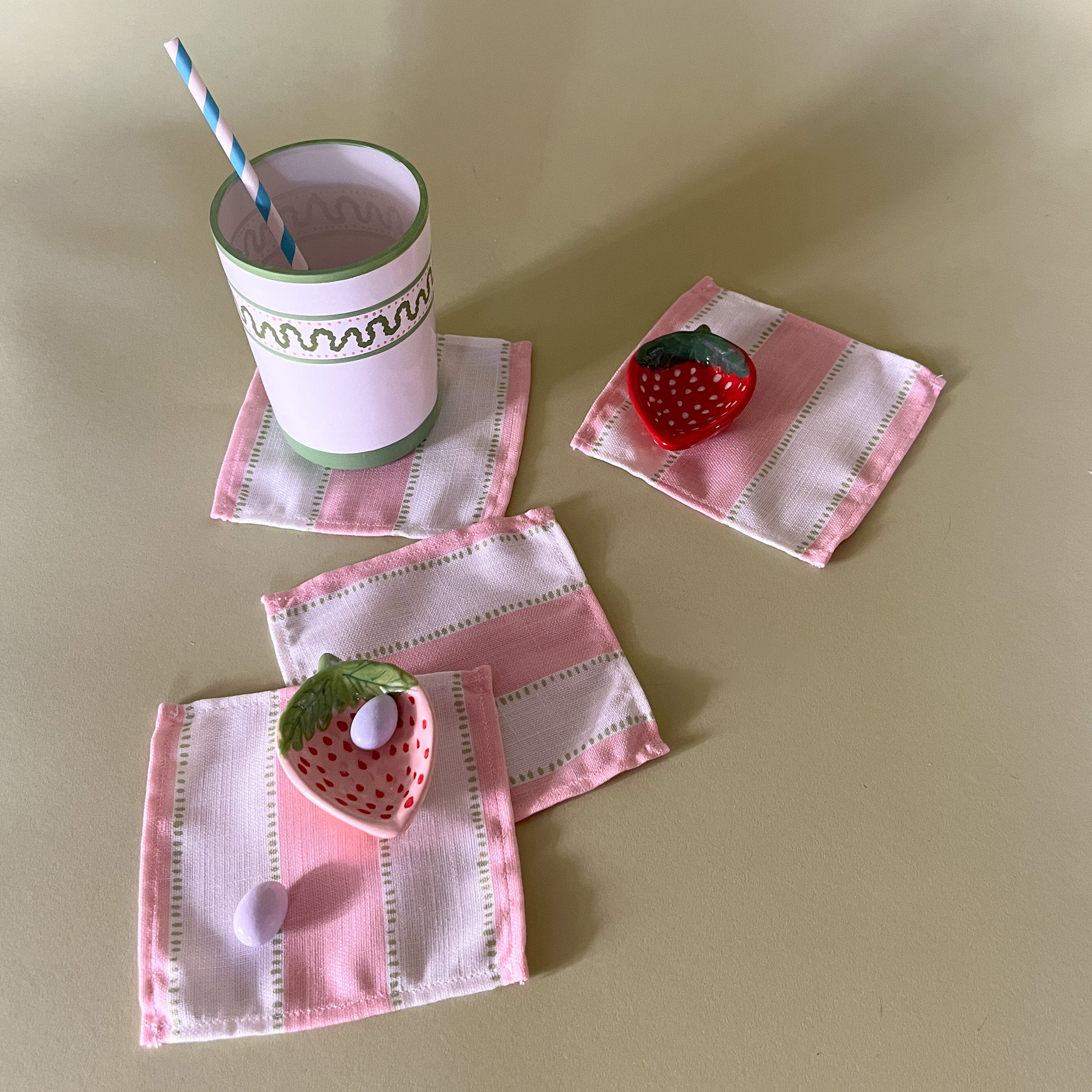 cabana boy pink and white stripe cloth cocktail napkins with strawberry accent dishes and cup