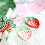 pink and red ceramic strawberry bowls on a strawberry decor themed tablescape
