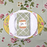 Easter egg Placemat with floral design, white plate, and green folded napkin on a matching tablecloth.