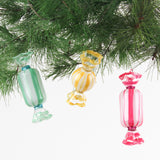 Colorful glass candy ornaments hanging on a Christmas tree.