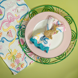 Lifestyle image of a multicolored Bunnies & Bow print cloth table runner and napkin in a bunny and bow print fabric.