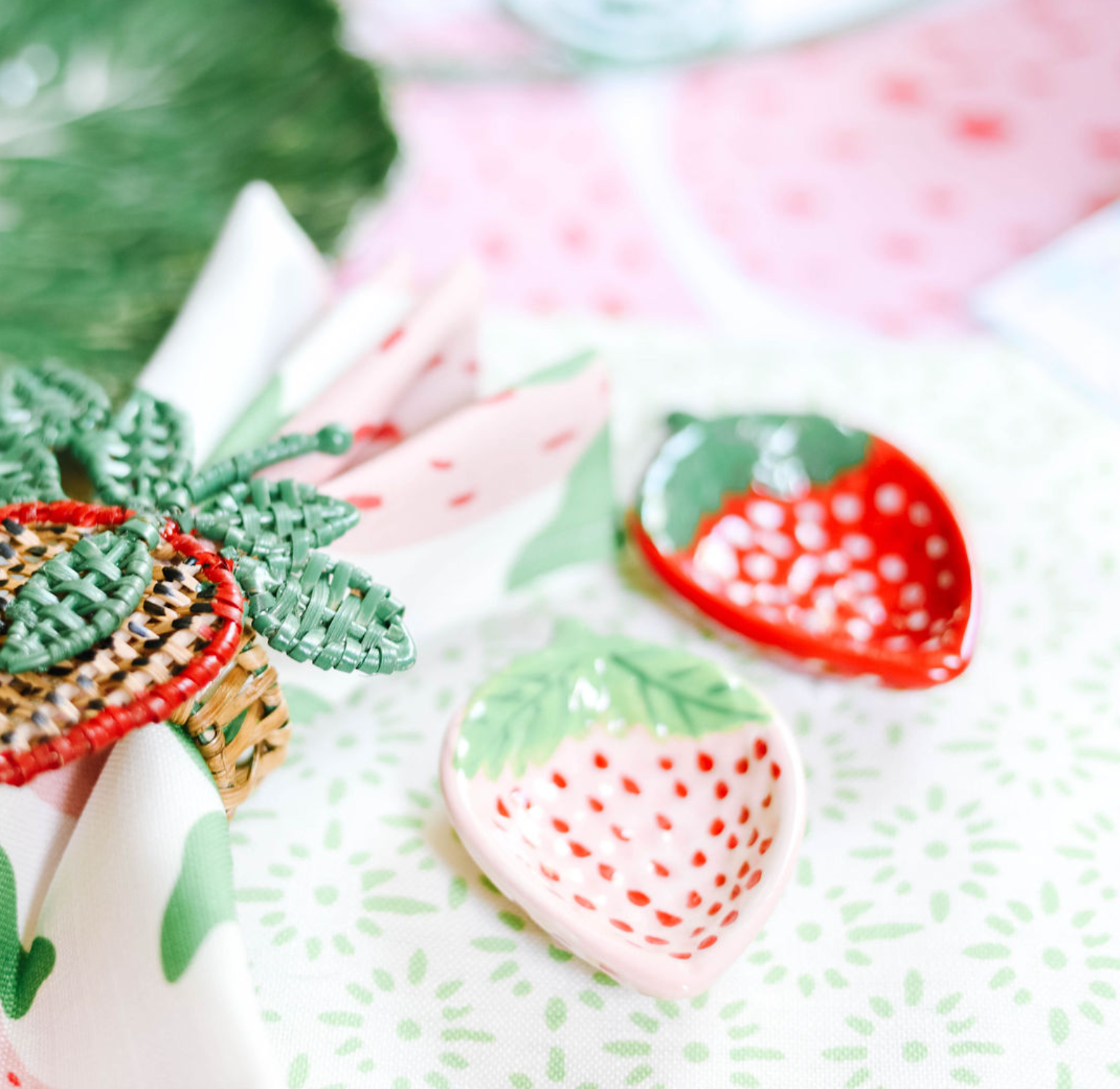 pink and red ceramic strawberry bowls on a strawberry decor themed tablescape