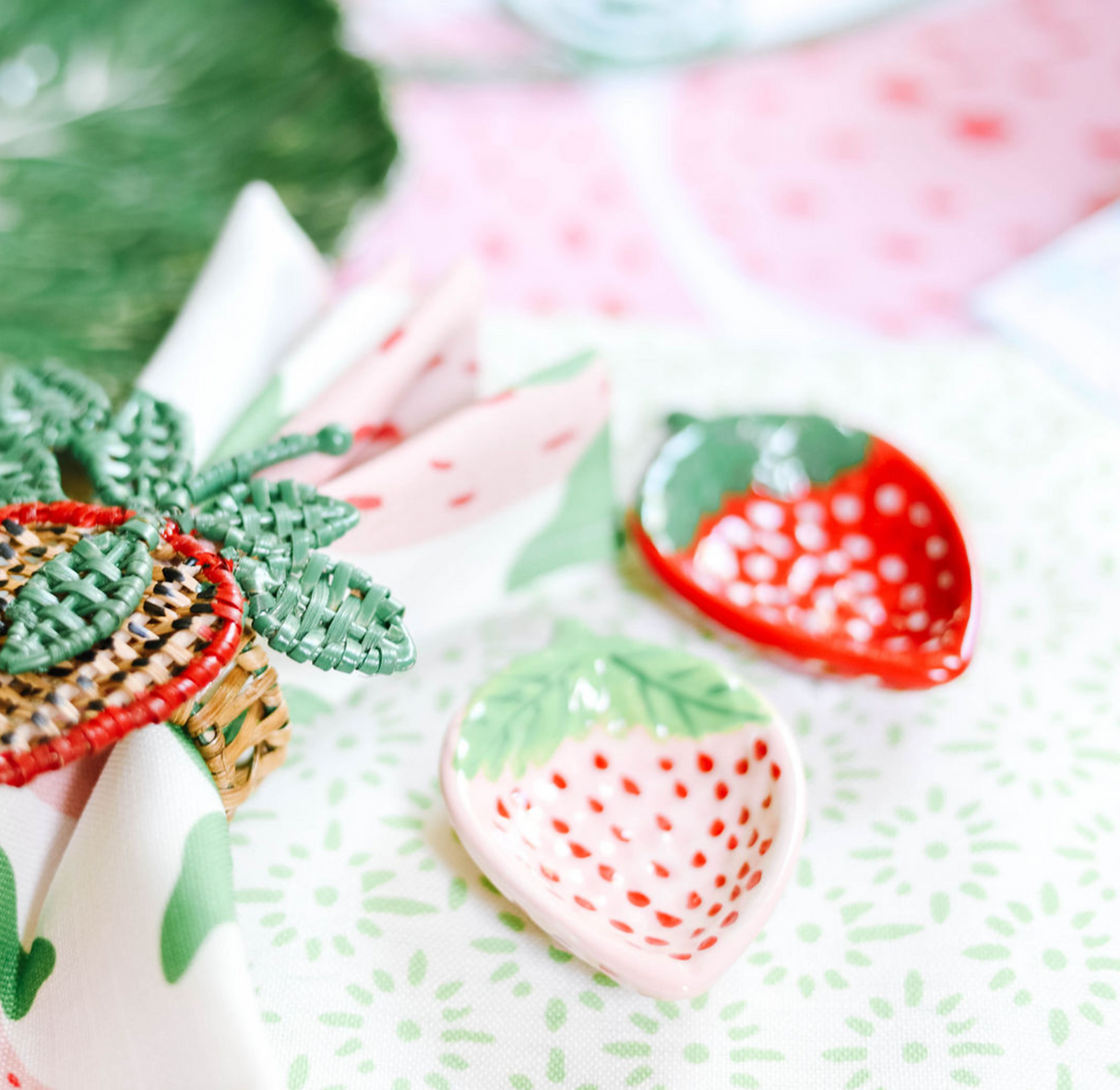 pink and red ceramic strawberry bowls on a strawberry decor themed tablescape