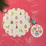 two round paper christmas doilies with a christmas ornament pattern from Madcap Cottage. 