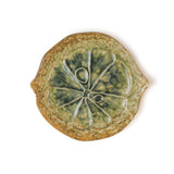 citrus fruit shaped ceramic plate with decorative citrus pattern on a white background