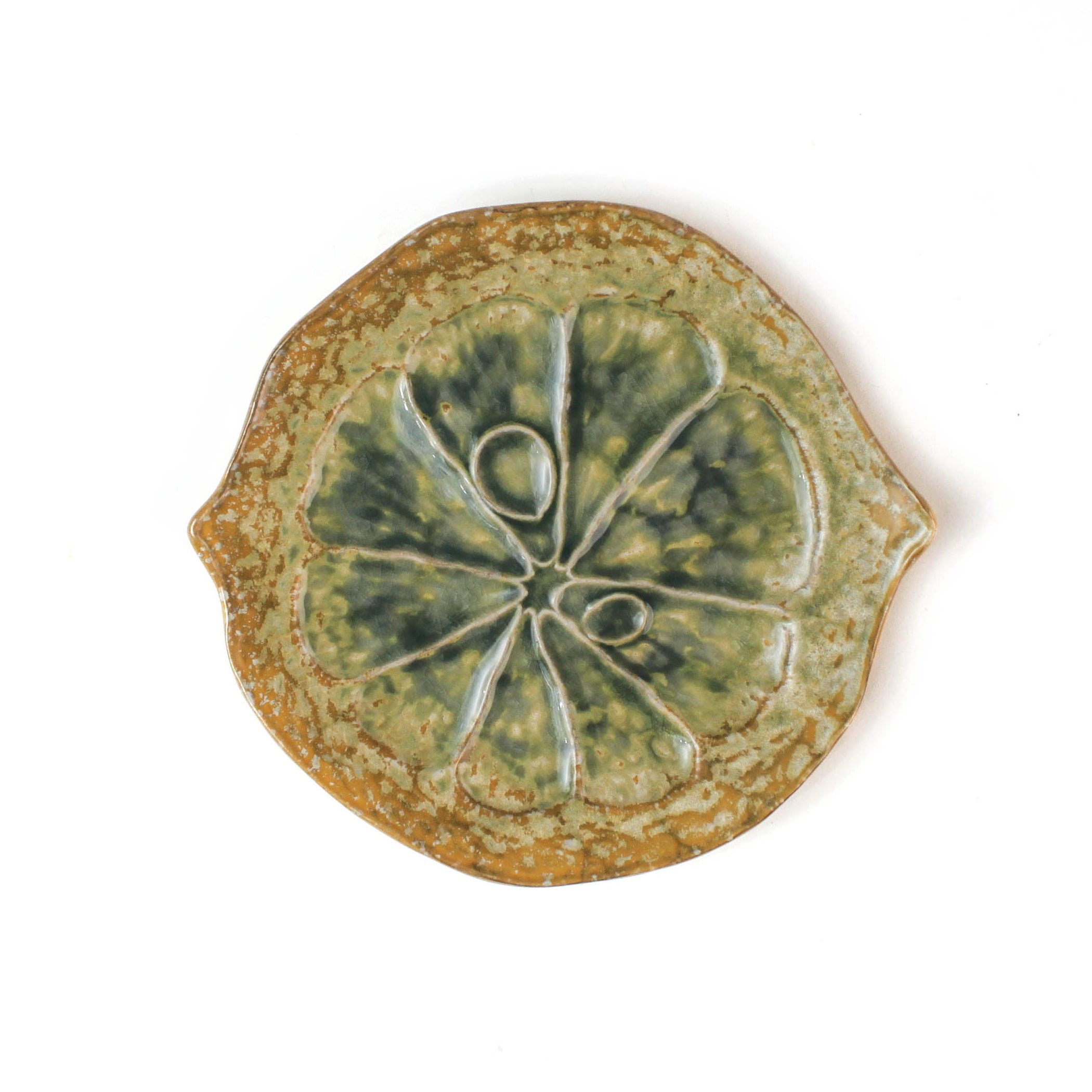 citrus fruit shaped ceramic plate with decorative citrus pattern on a white background
