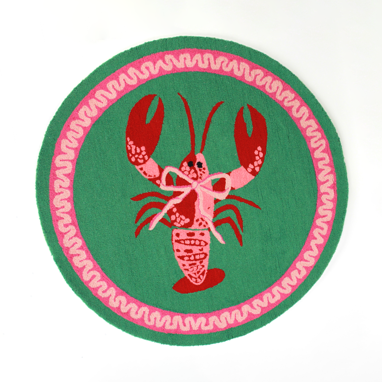 A round green and pink rug with a central red and pink lobster motif.