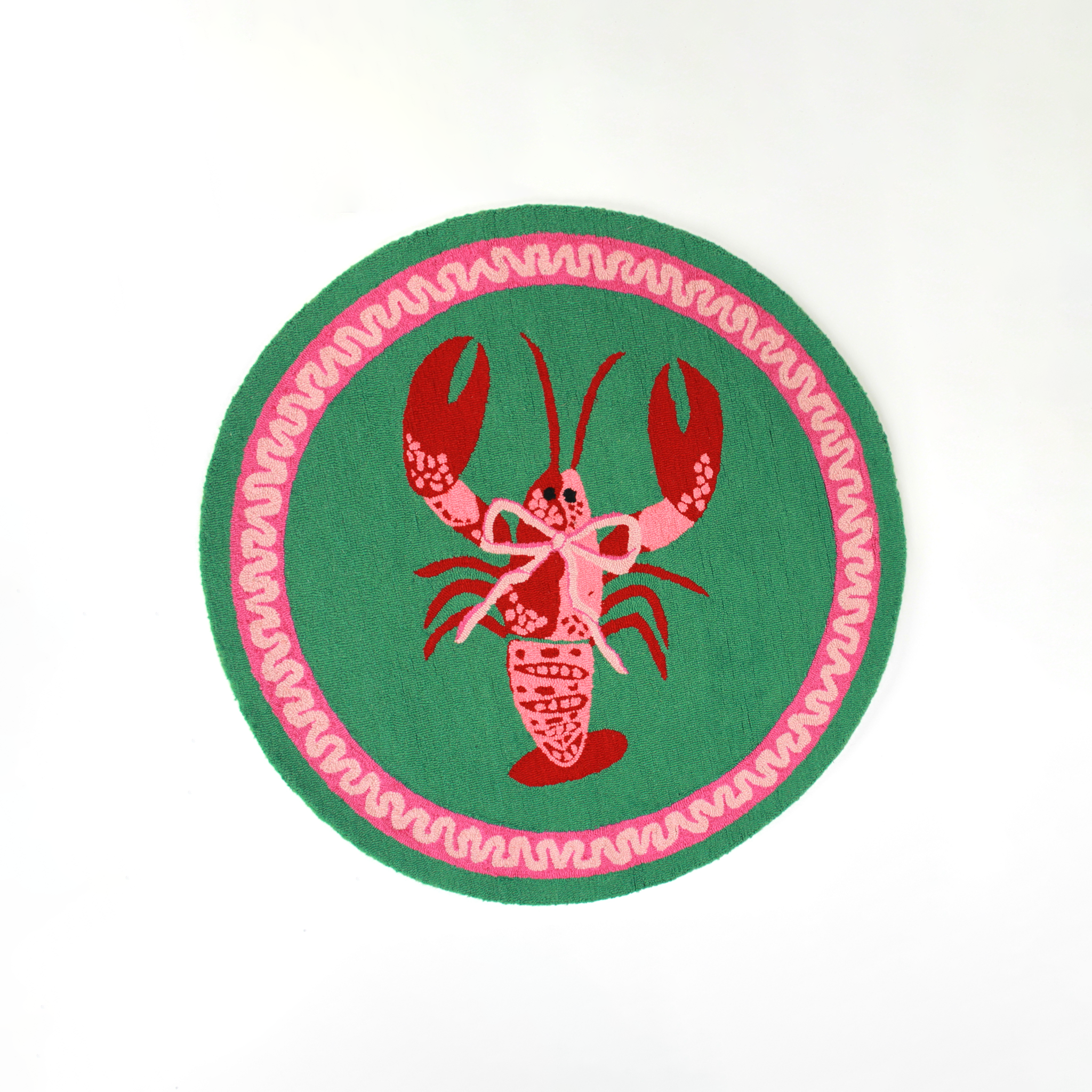 A round green and pink rug with a central red and pink lobster motif.