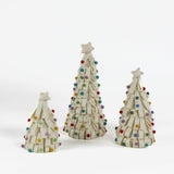 A set of three looped felt white christmas tree table decorations in graduating sizes from small to large with a white star on top and coloured felt ornaments dotted around the trees against a white background. 