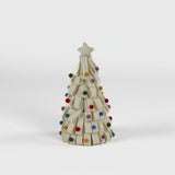 a looped felt white christmas tree table decoration iwith a white star on top and coloured felt ornaments dotted around the trees against a white background. 
