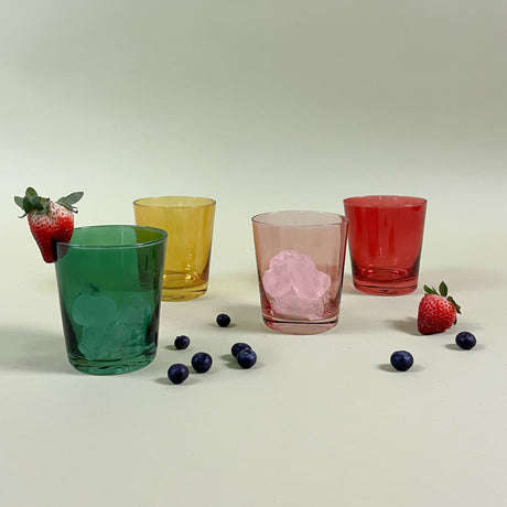 Four colored drinking glasses in pink, red, green and yellow from madcap cottage