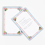 luxury christmas notepads with ornament and holly motifs against a white background.