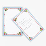 luxury christmas notepads with ornament and holly motifs against a white background.