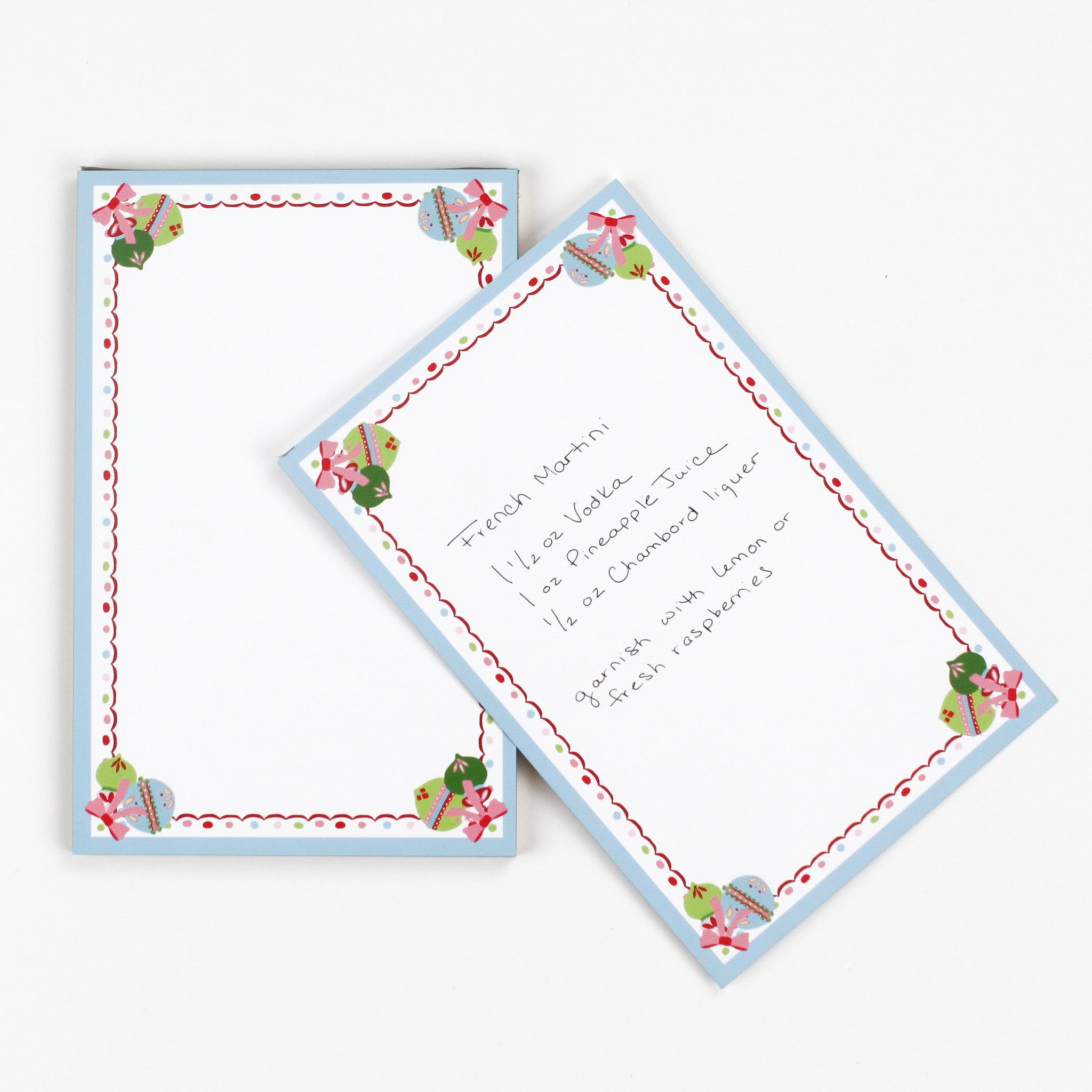 luxury christmas notepads with ornament and holly motifs against a white background.