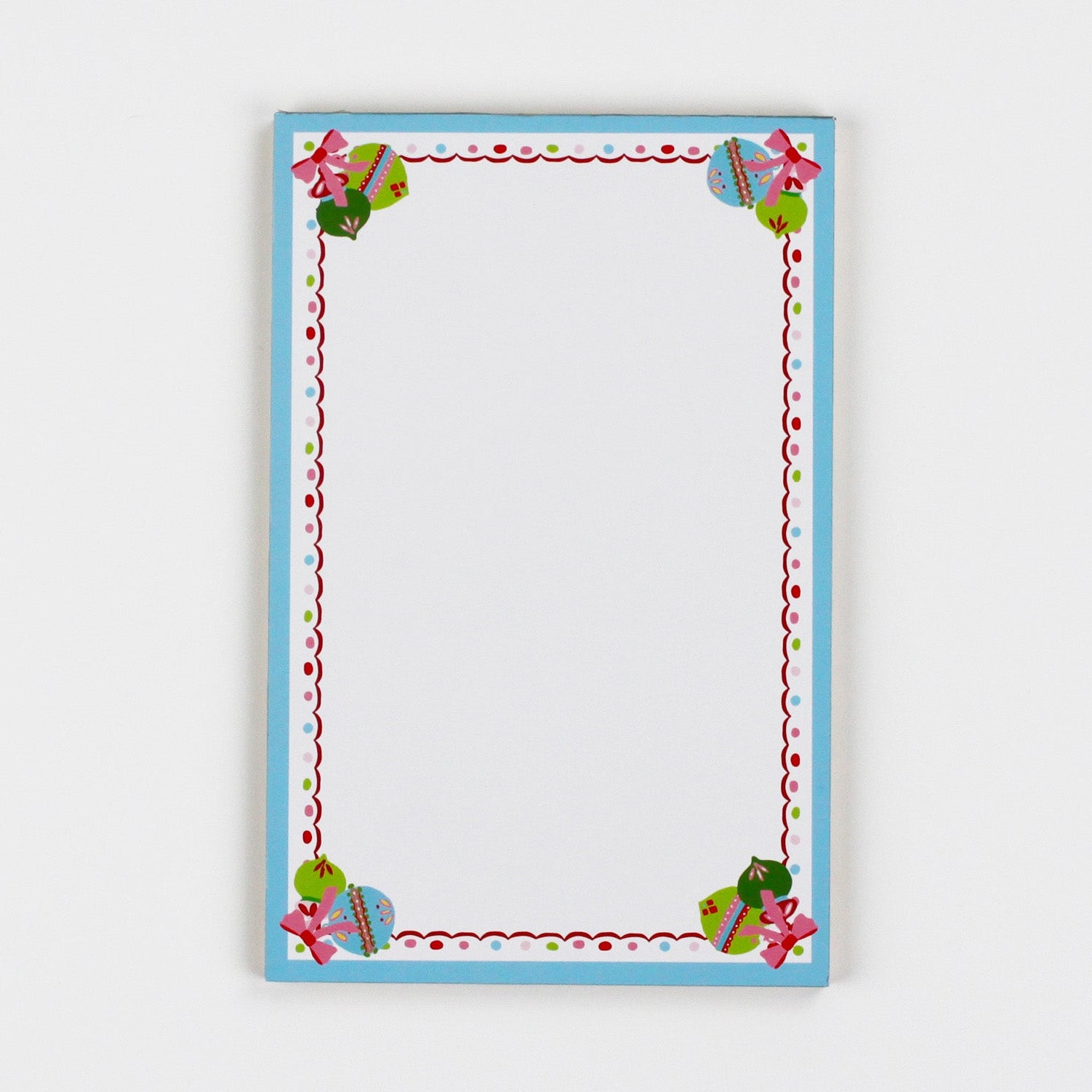 luxury christmas notepads with ornament and holly motifs against a white background.
